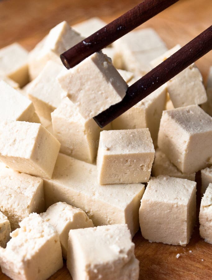 cubes-raw-tofu-two-chopsticks-one-close-up-70738369.jpg